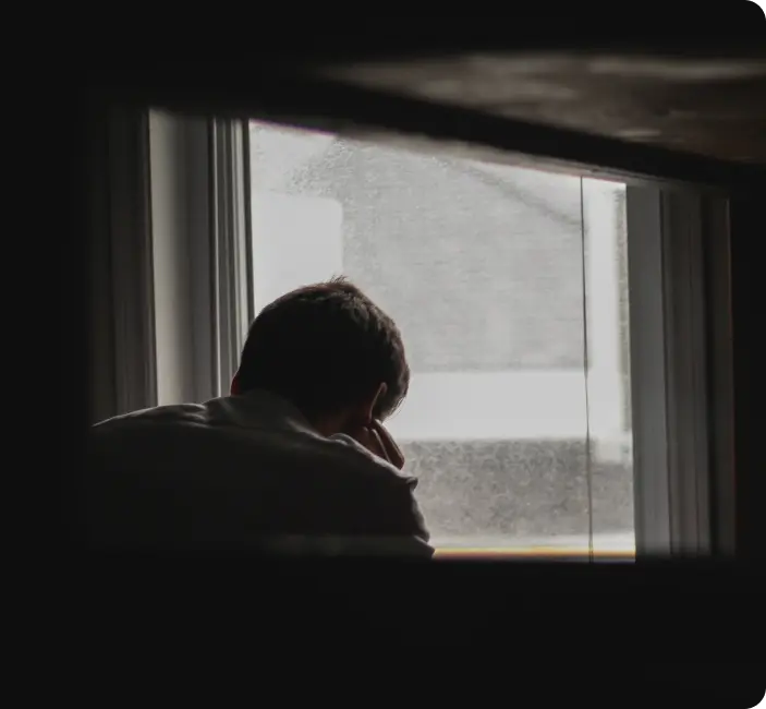 A man looking out of a window.