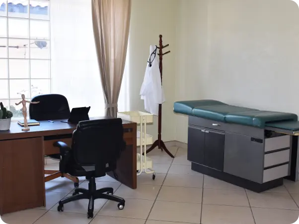 A doctor's office with a desk and chair.