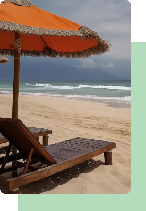 Two lounge chairs on a beach with an orange umbrella.